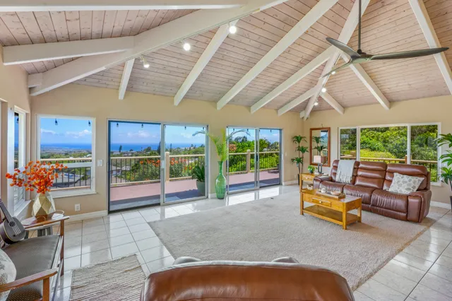 a living room with patio furniture and a floor to ceiling window