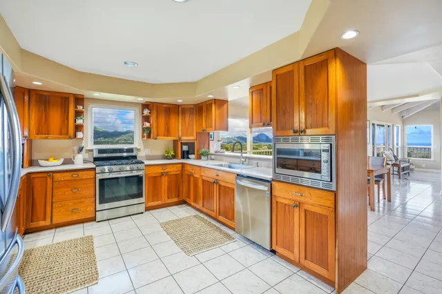 a kitchen with stainless steel appliances granite countertop a stove top oven a sink dishwasher and cabinets
