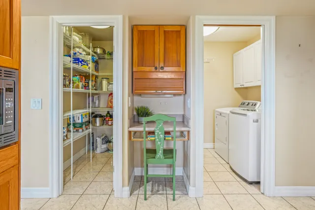 a view of a hallway with dining area and glass door