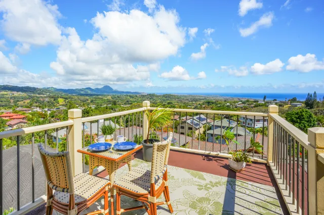 a view of a chairs and table on the balcony