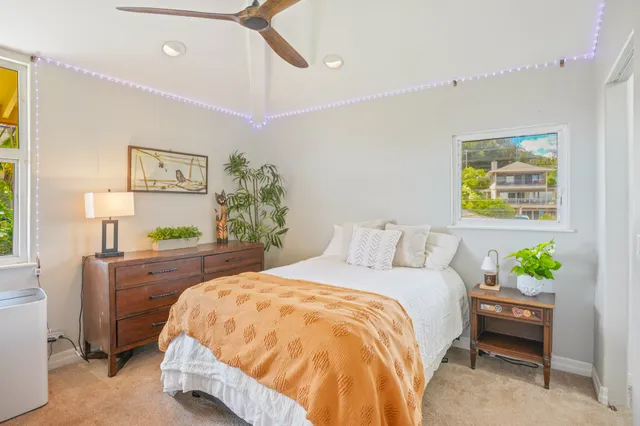 a bed sitting in a bedroom next to a wooden floor