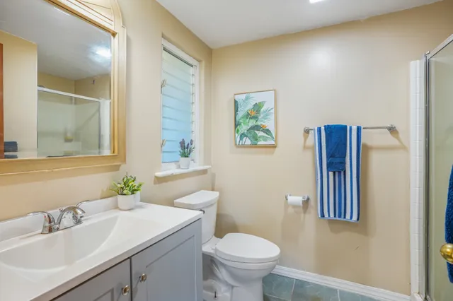 a bathroom with a sink toilet and mirror