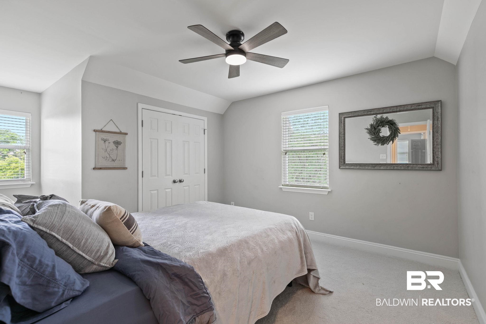 22810 High Ridge Road Fairhope, AL 36532 - Photo 42 of 78 Bedroom featuring a vaulted ceiling with a ceiling fan, light gray wall paint, two windows with blinds, and white bi-fold closet doors
