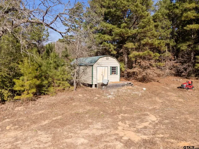 a view of a porch with furniture and a yard