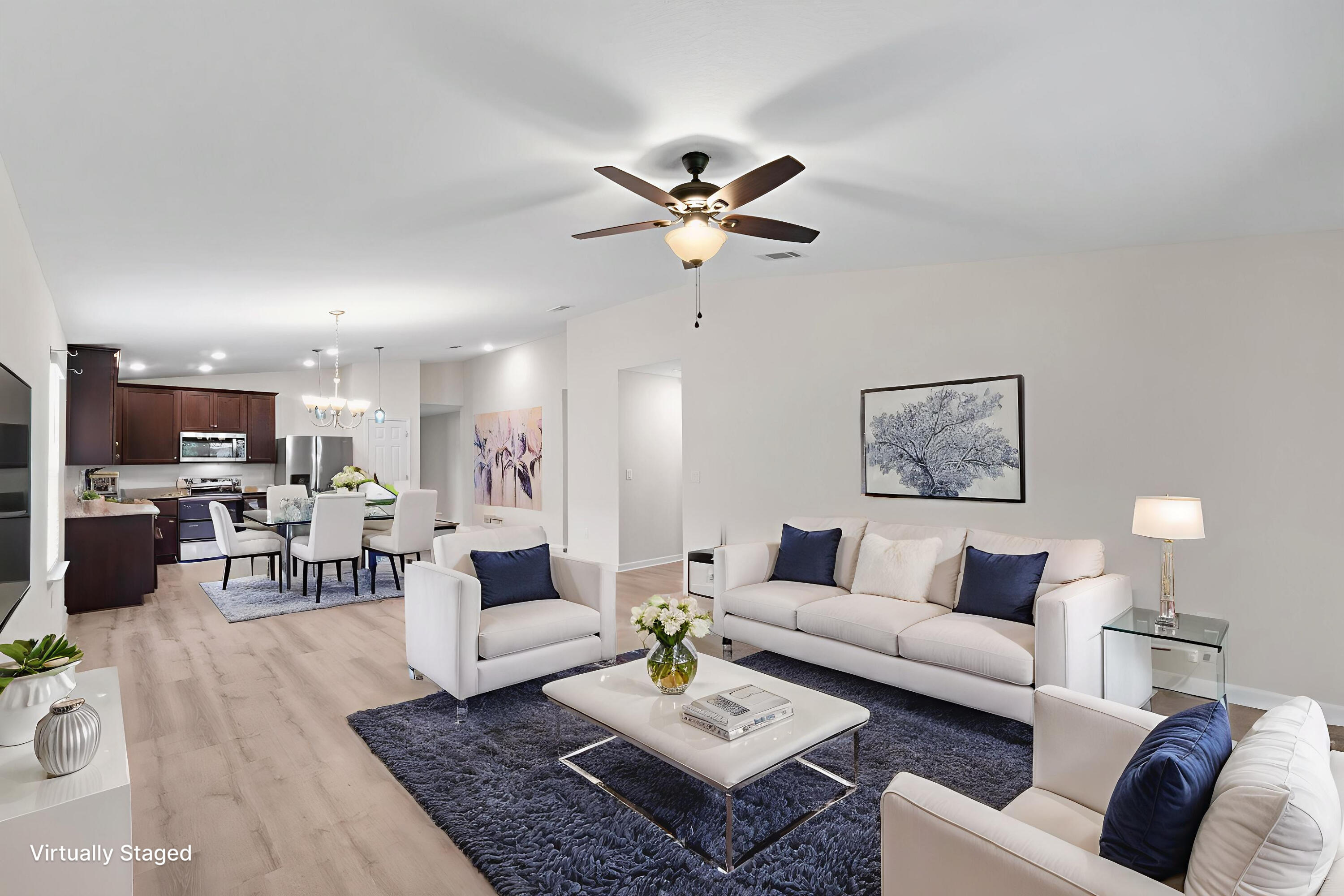 378 Marquis Way Freeport, FL 32439 - Photo 11 of 37 a living room with furniture a rug and a chandelier