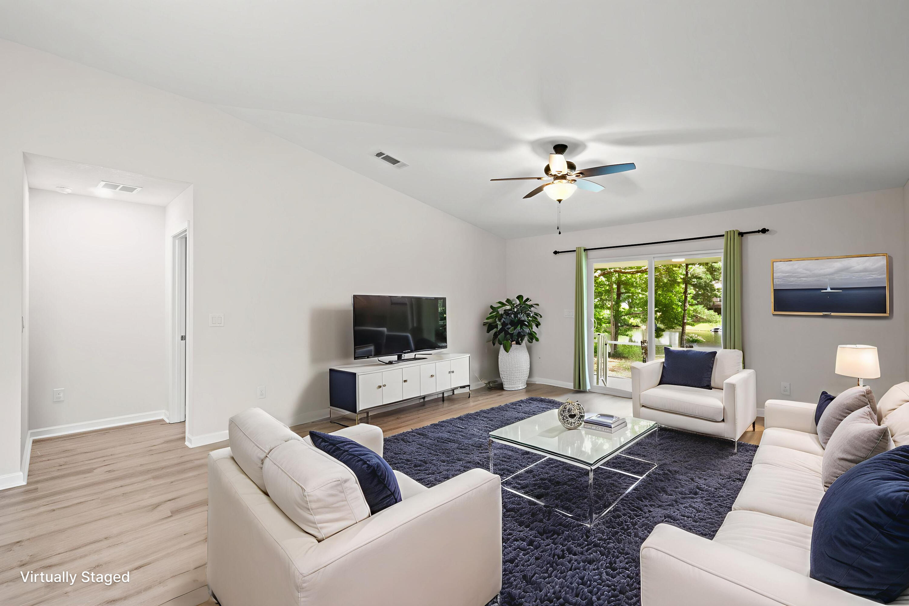 378 Marquis Way Freeport, FL 32439 - Photo 13 of 37 a living room with furniture a flat screen tv and a large window