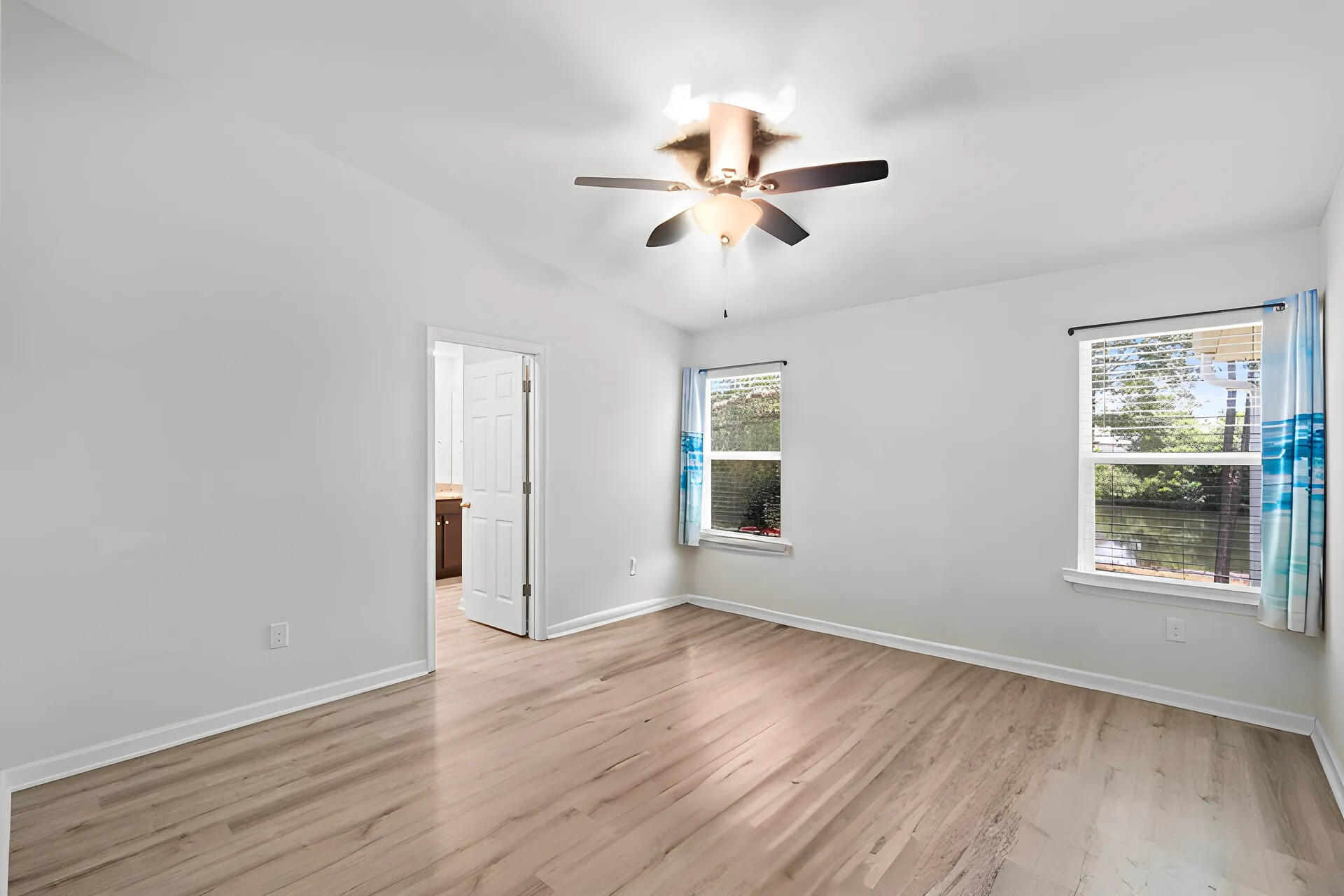 378 Marquis Way Freeport, FL 32439 - Photo 14 of 37 a view of an empty room with wooden floor and a window
