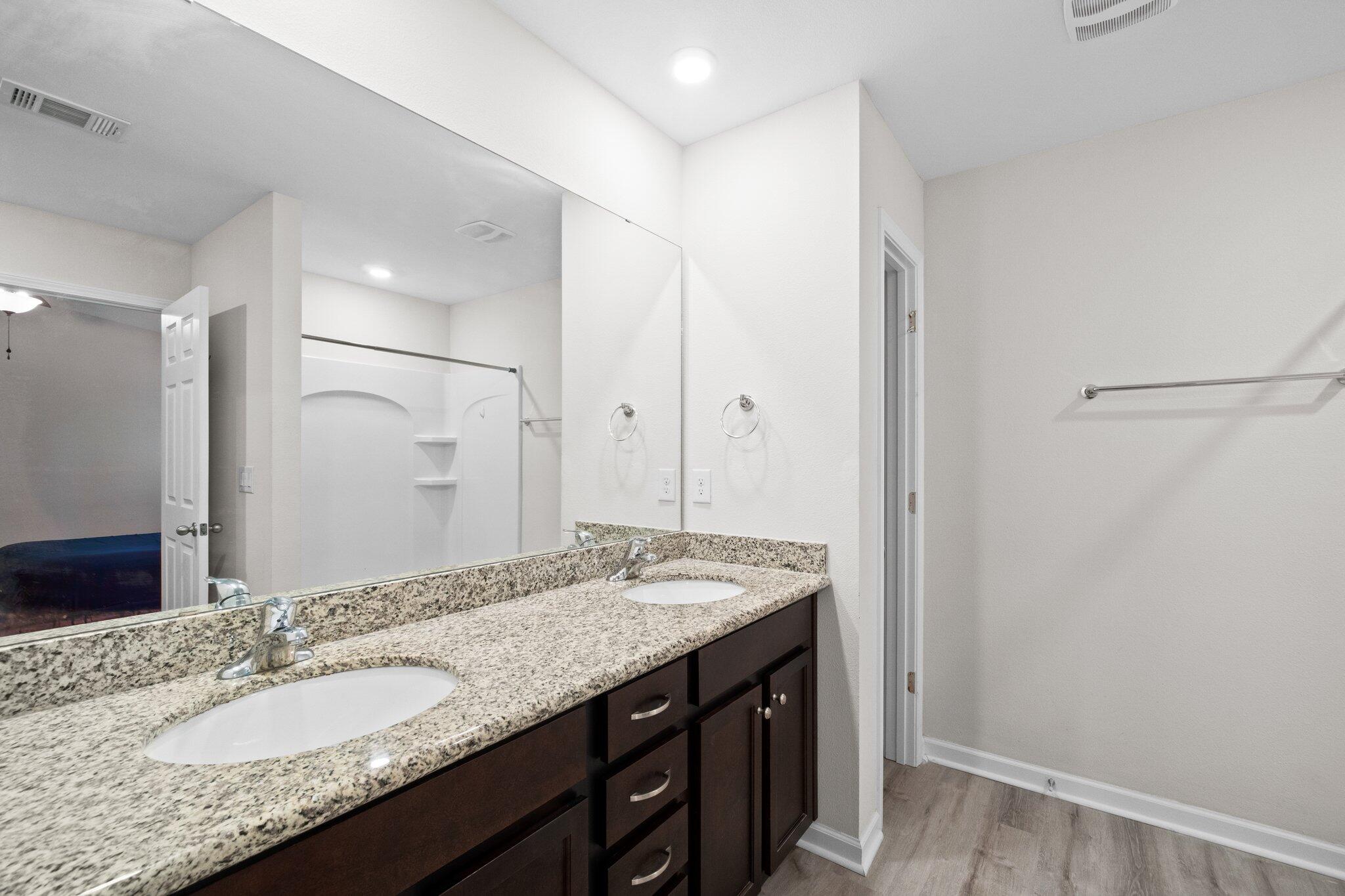 378 Marquis Way Freeport, FL 32439 - Photo 16 of 37 a bathroom with a granite countertop sink and a mirror