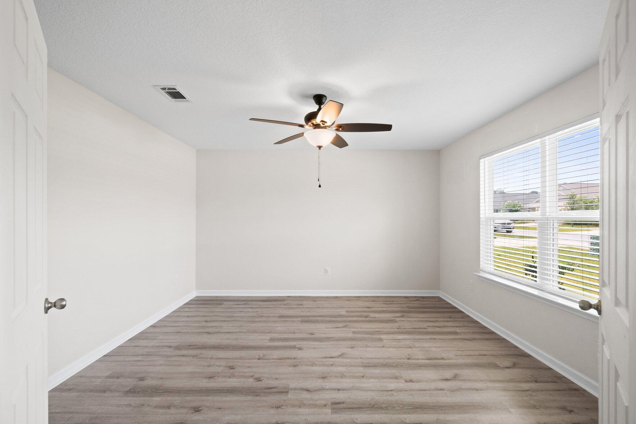 378 Marquis Way Freeport, FL 32439 - Photo 20 of 37 a view of an empty room with wooden floor and a window