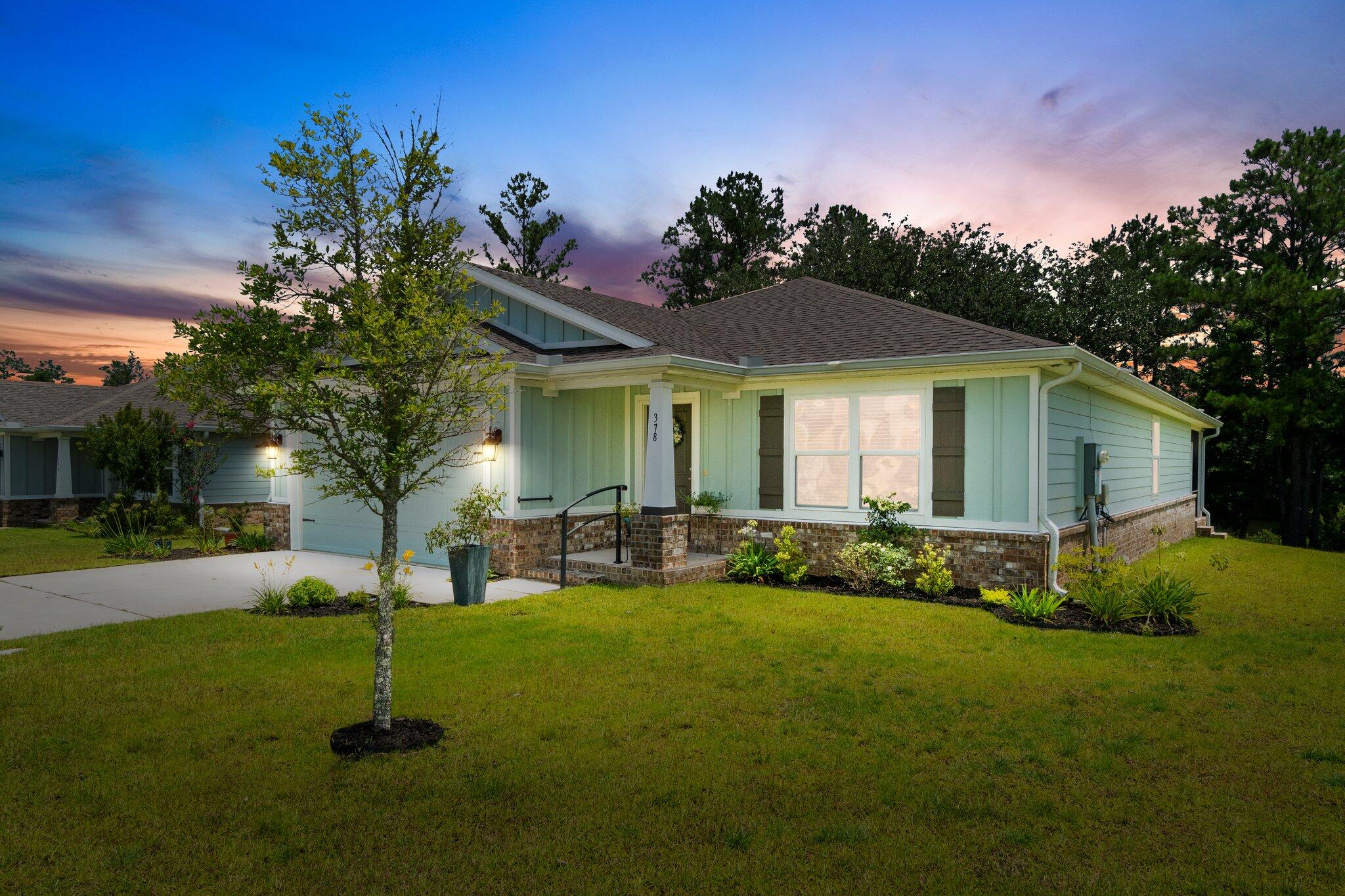 378 Marquis Way Freeport, FL 32439 - Photo 2 of 37 a front view of a house with garden