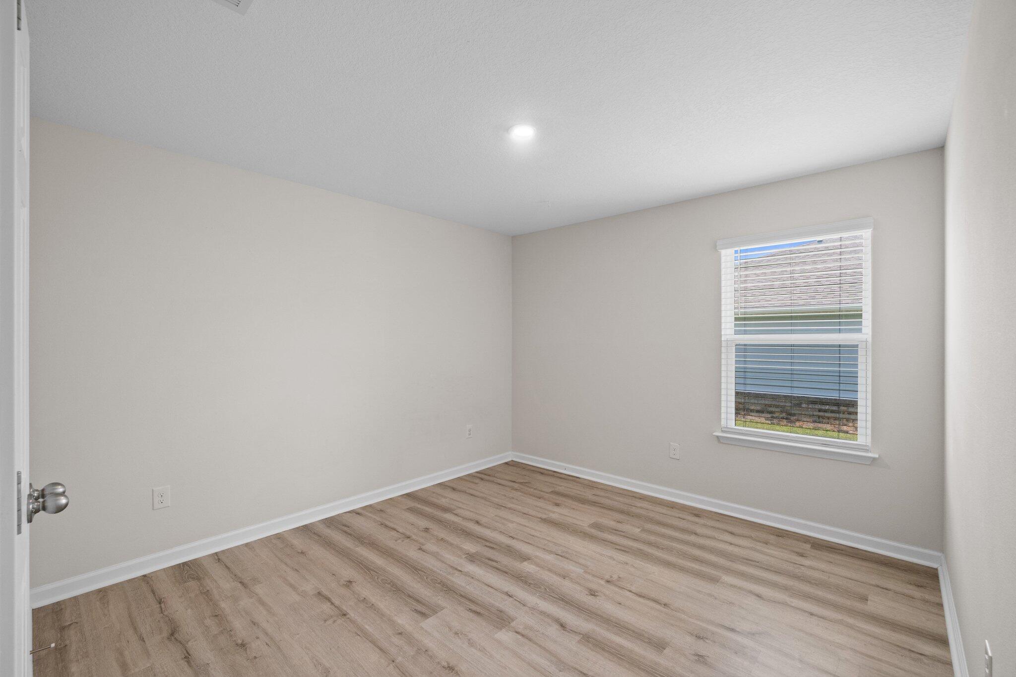 378 Marquis Way Freeport, FL 32439 - Photo 28 of 37 wooden floor in an empty room with a window