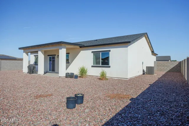 a view of a house with a backyard