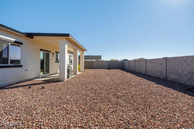 a view of a house with wooden fence