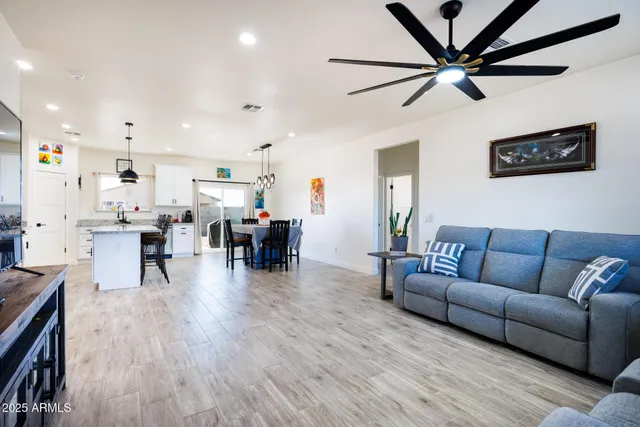 a living room with furniture and kitchen view