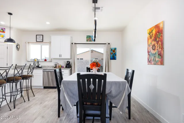 a view of a dining room with furniture window and wooden floor