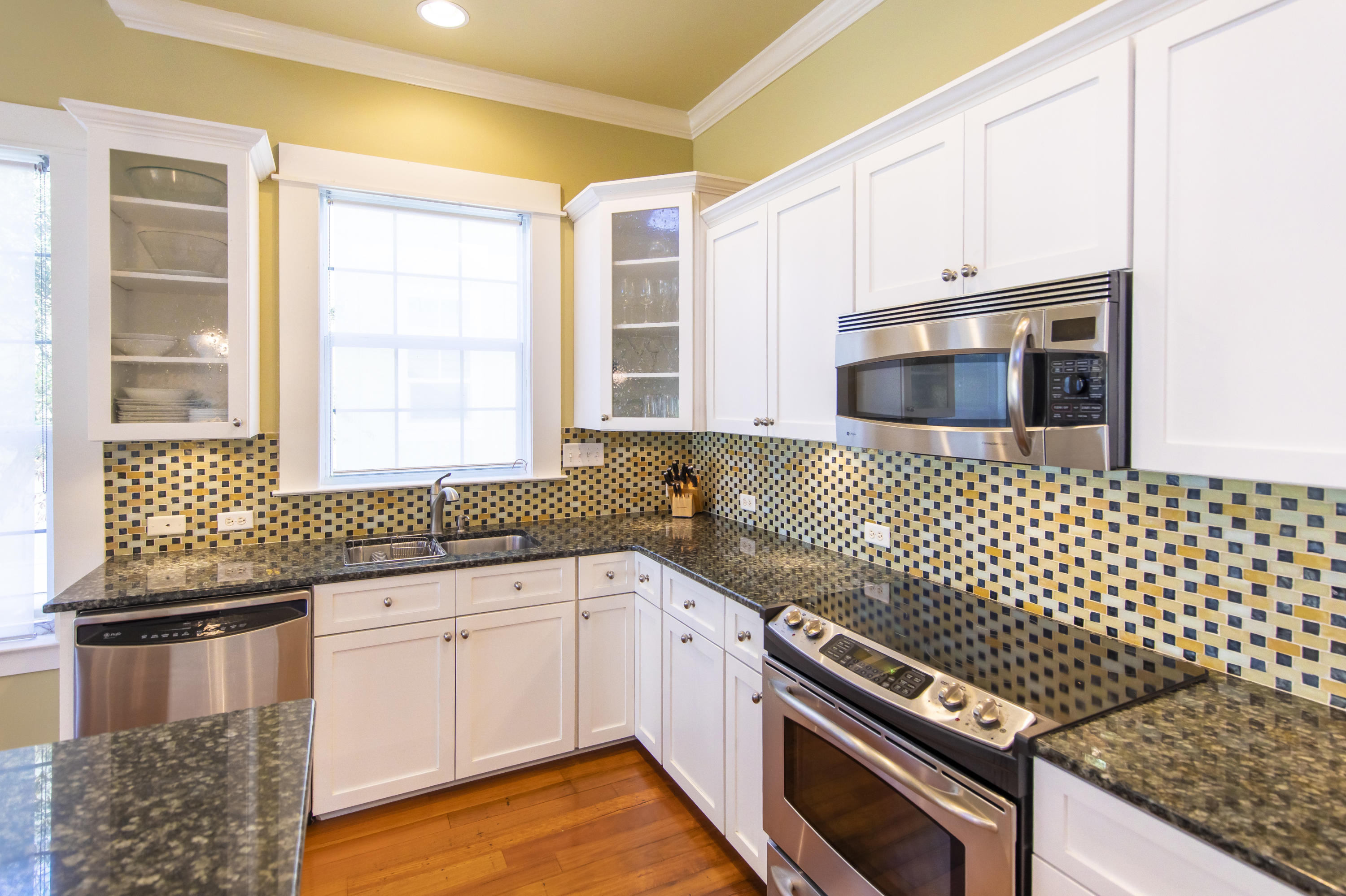 276 Grande Pointe Circle Inlet Beach, FL 32461 - Photo 11 of 33 a kitchen with granite countertop a stove a sink and a microwave