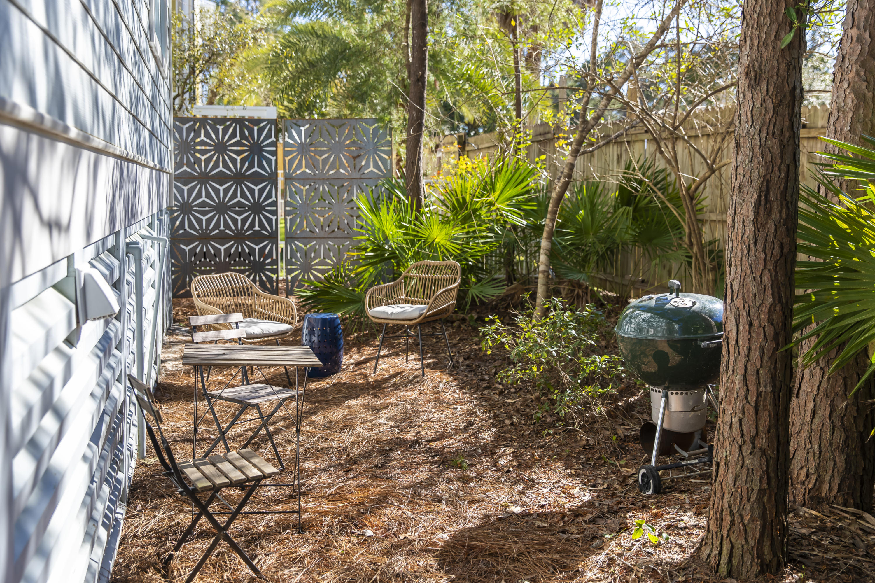 276 Grande Pointe Circle Inlet Beach, FL 32461 - Photo 27 of 33 a backyard of a house with table and chairs