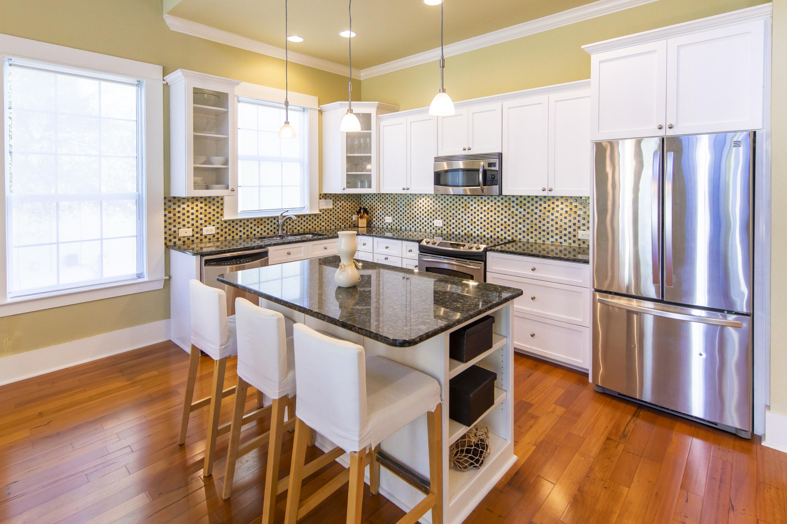 276 Grande Pointe Circle Inlet Beach, FL 32461 - Photo 10 of 33 a kitchen with stainless steel appliances granite countertop a sink a stove a refrigerator and island with wooden floor
