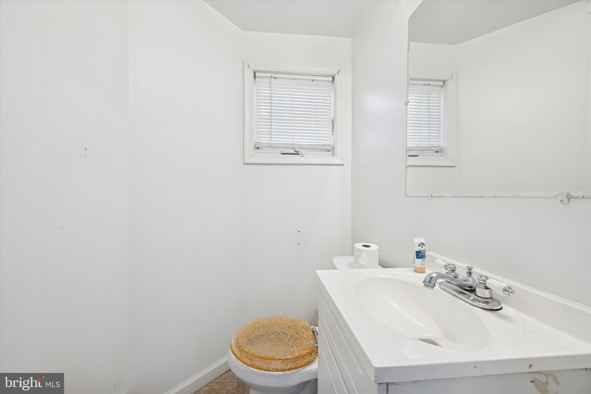 1004 Sunset Street Marcus Hook, PA 19061 - Photo 5 of 19 a bathroom with a sink a toilet and mirror