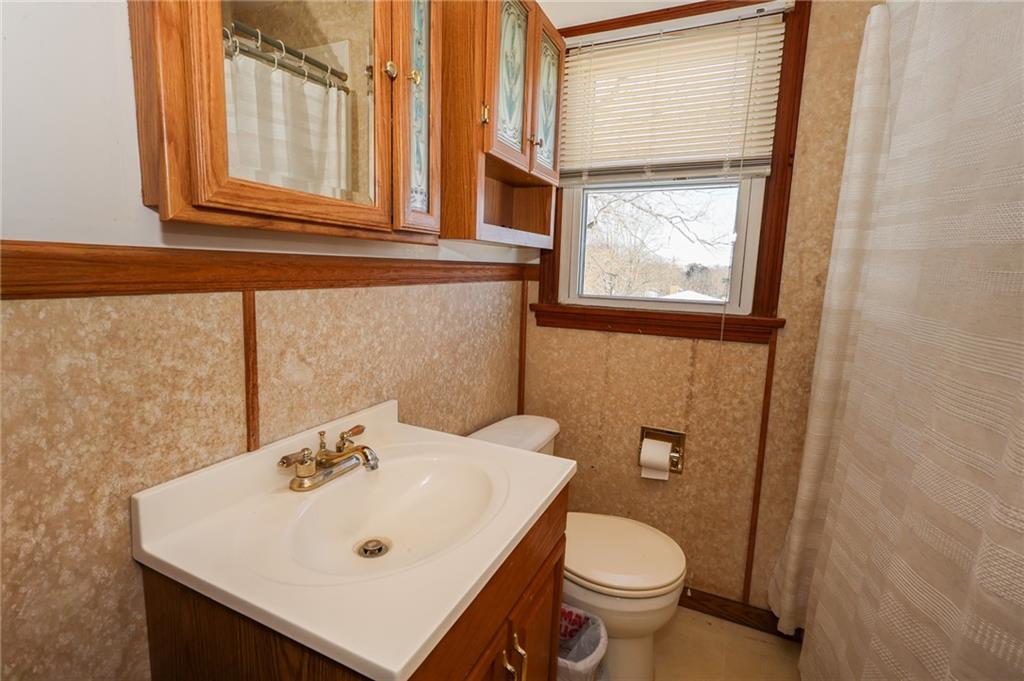 521 Mercer-New Wilmington Road Mercer, PA 16137 - Photo 12 of 35 a bathroom with a sink a toilet and a mirror