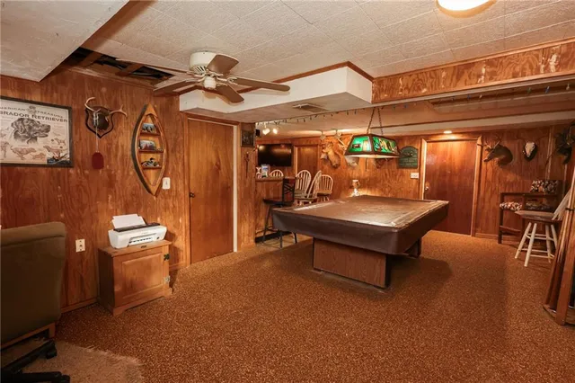 a living room with furniture a rug and white walls