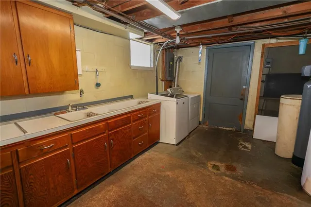 a room with a sink a mirror and a shower