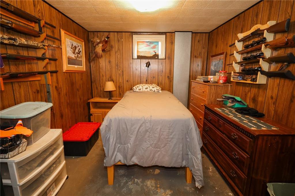 521 Mercer-New Wilmington Road Mercer, PA 16137 - Photo 22 of 35 a bedroom with a bed and a chandelier