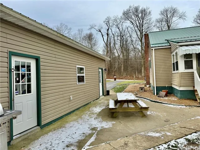 a view of a patio with a table and chairs and floor to ceiling window