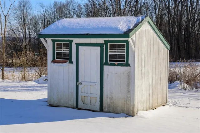 a view of small house with wooden fence