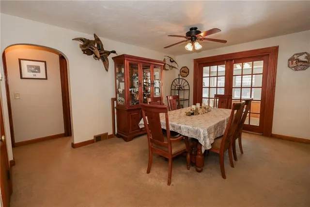 a view of a dining room with furniture and a chandelier