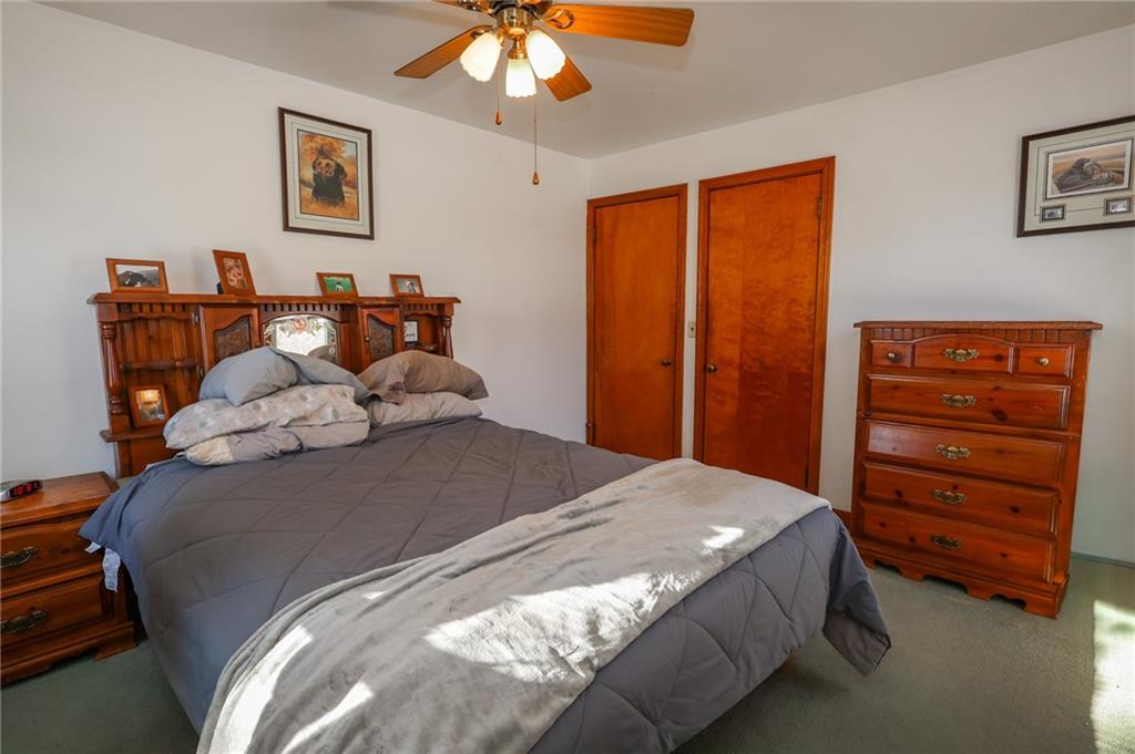 521 Mercer-New Wilmington Road Mercer, PA 16137 - Photo 8 of 35 a bedroom with a bed and a chandelier