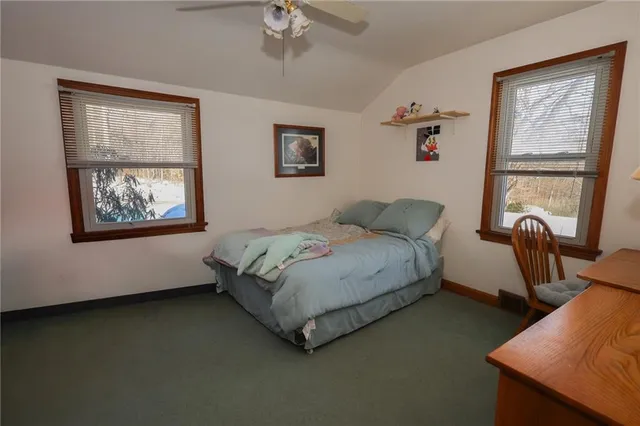 a spacious bedroom with a bed and a window