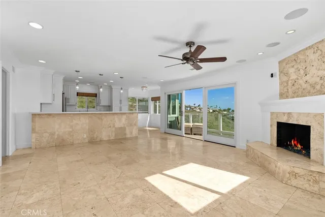 a view of an empty room with a fireplace and a window