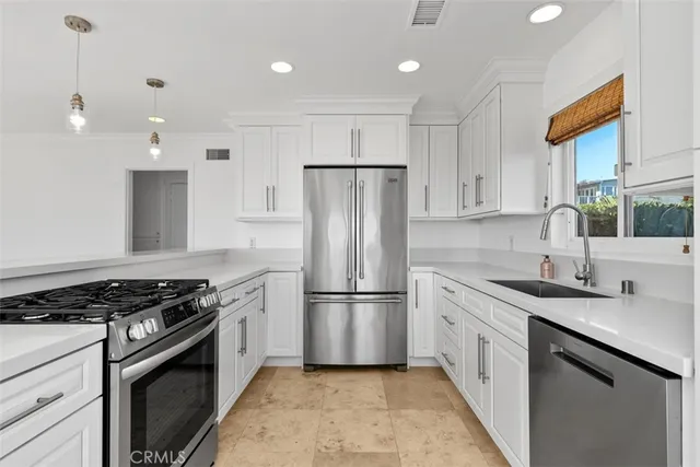 a large kitchen with kitchen island a large window and a sink