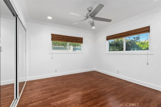 an empty room with windows and a fireplace