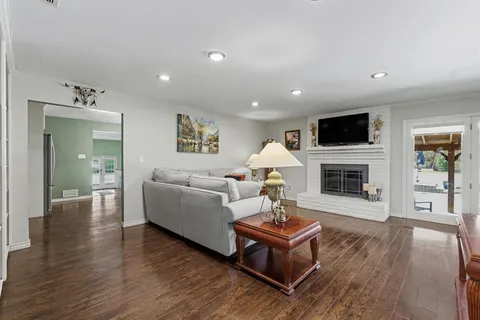 a living room with furniture fireplace and a flat screen tv