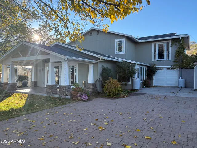 a view of a house with backyard and sitting area