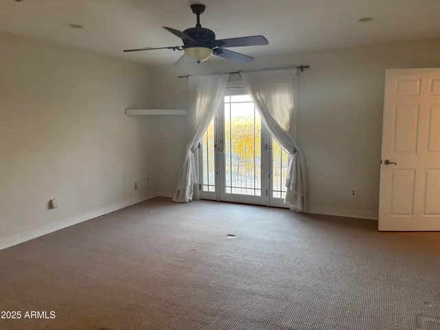 an empty room with a window and a projector