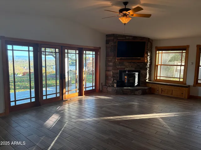 a living room with fireplace furniture and a wooden floor