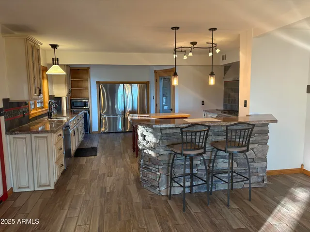 a dining room with furniture and wooden floor