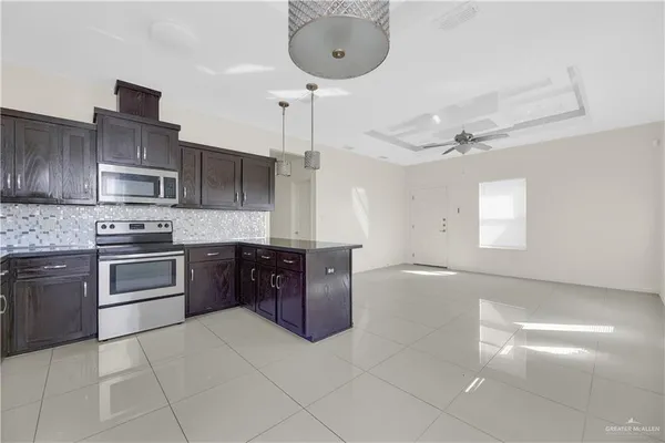 a kitchen with stainless steel appliances granite countertop a sink and cabinets