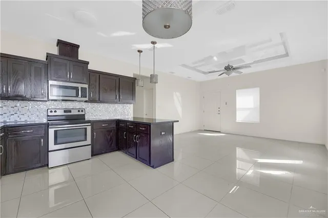 a kitchen with stainless steel appliances granite countertop a sink and cabinets