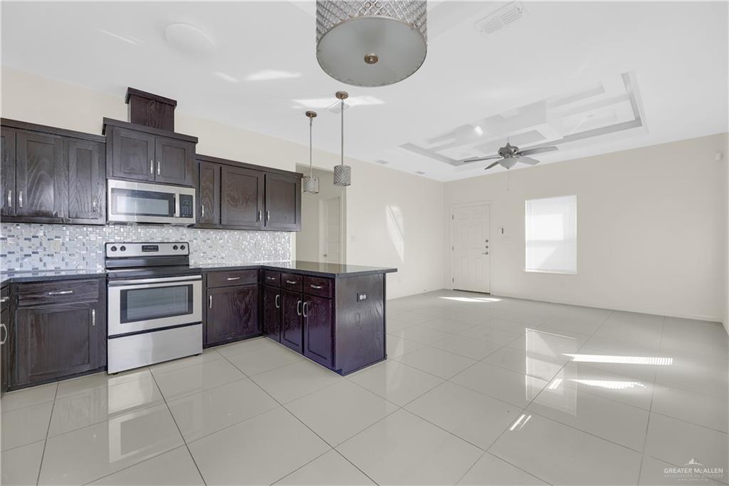1017 East Myrtle Beach Avenue McAllen, TX 78503 - Photo 11 of 18 a kitchen with stainless steel appliances granite countertop a sink and cabinets