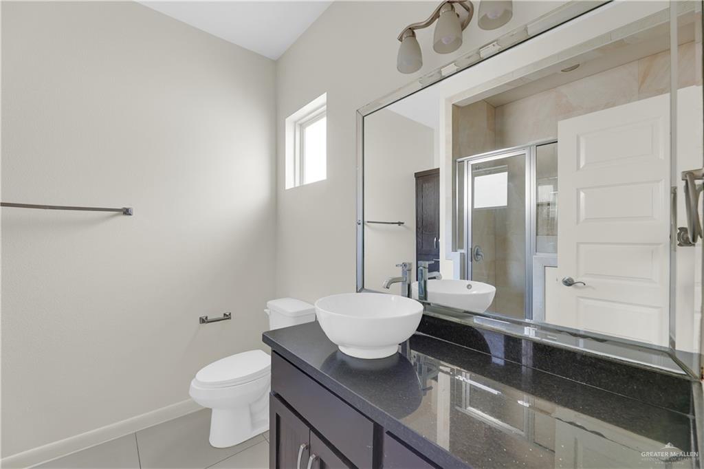 1017 East Myrtle Beach Avenue McAllen, TX 78503 - Photo 14 of 18 a bathroom with a sink a toilet and shower