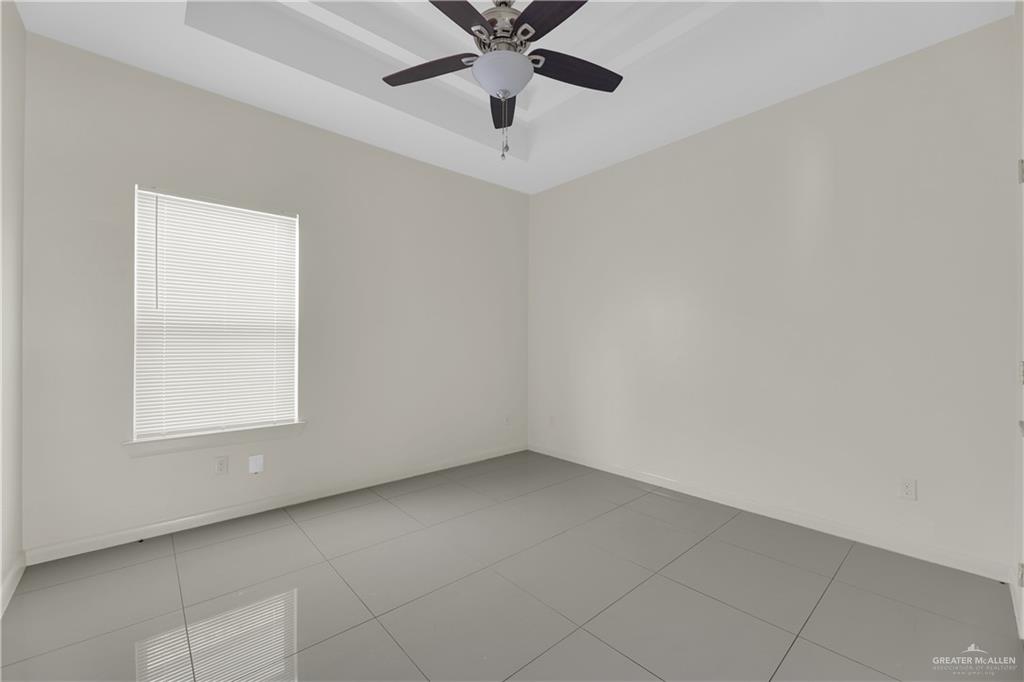 1017 East Myrtle Beach Avenue McAllen, TX 78503 - Photo 15 of 18 an empty room with a window and a fan