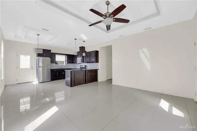 a large kitchen with cabinets and stainless steel appliances