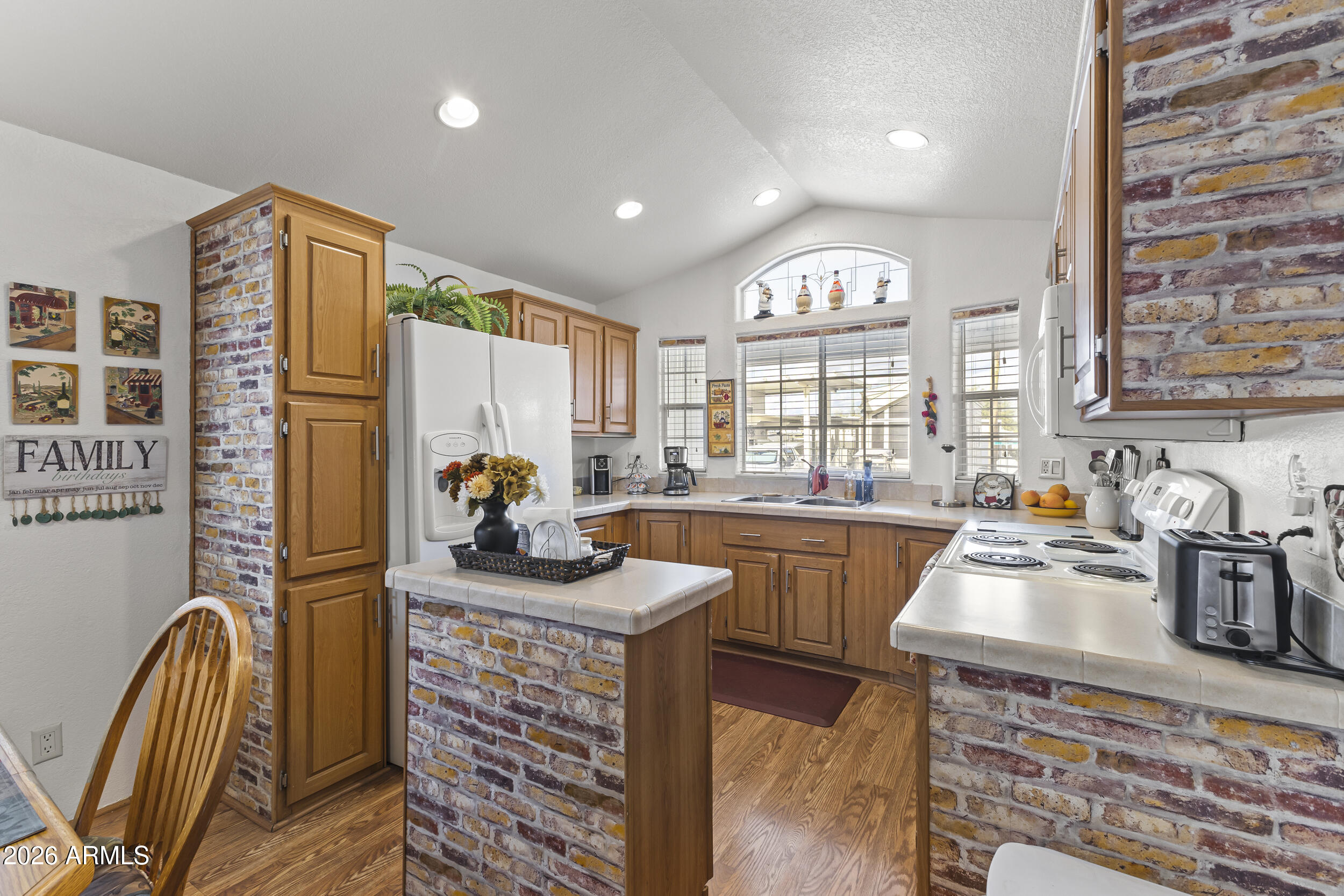 17200 West Bell Road, Unit 548 Surprise, AZ 85374 - Photo 6 of 19 a kitchen with sink refrigerator and window