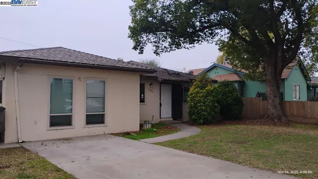 a house that has a tree in front of it