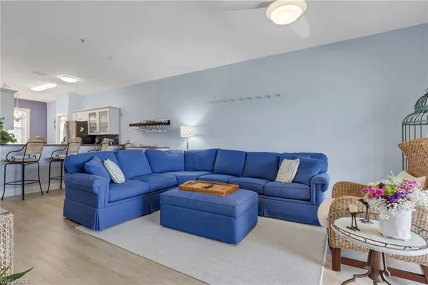 a living room with furniture and kitchen view
