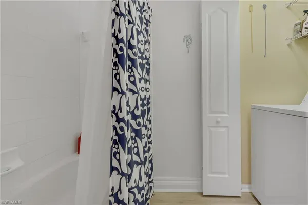 a bathroom with a shower curtain and a window